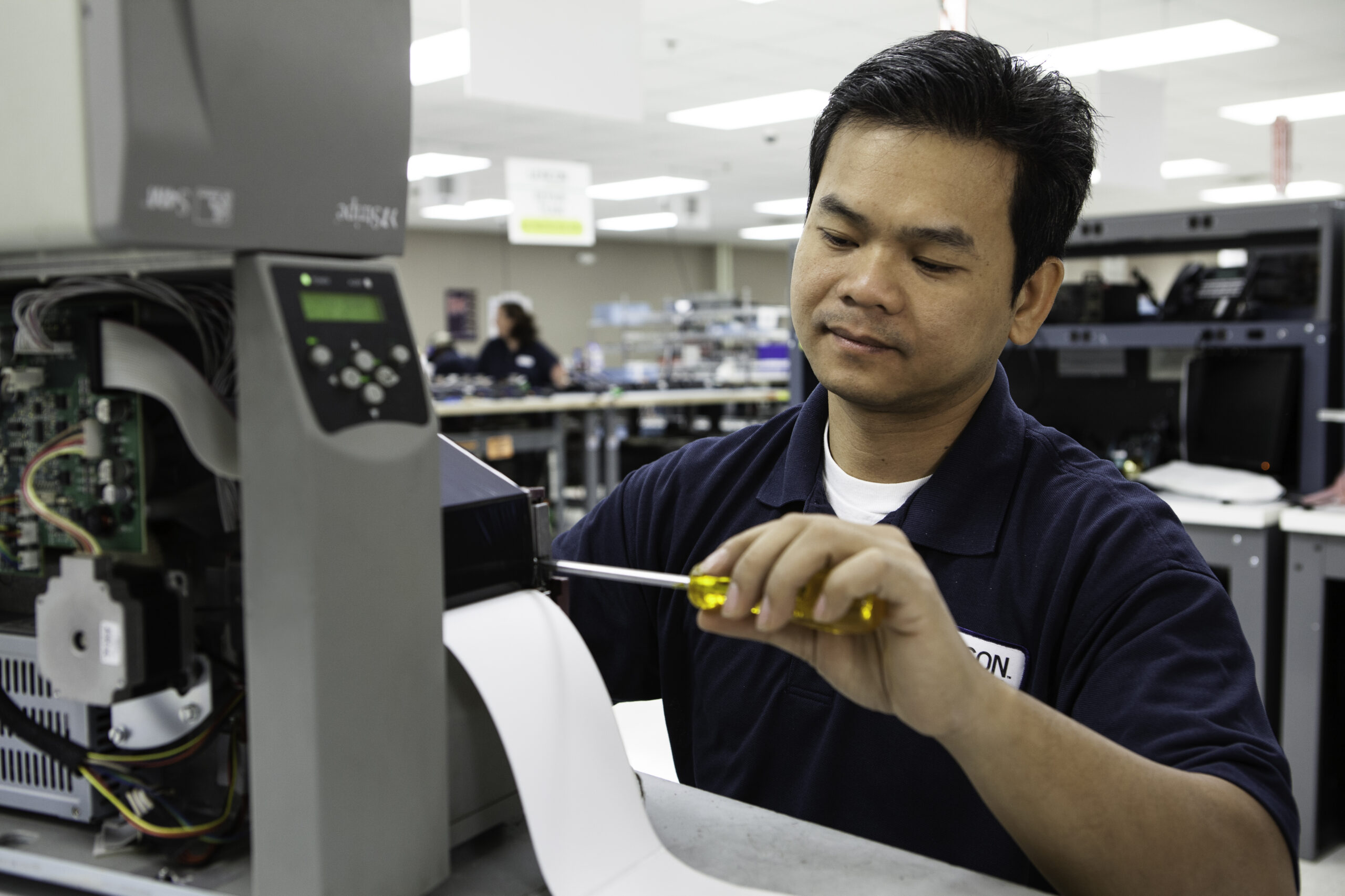 Lexicon technician working on refurbished printer